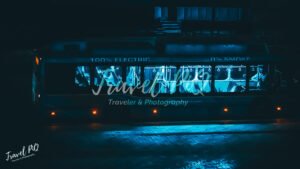 Electric City Bus at Night with Interior Lights and Zero Emissions Concept